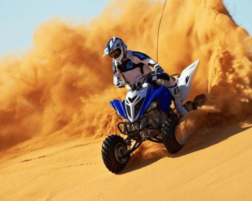 Thrilling desert safari Dubai quad biking adventure through the golden sand dunes.